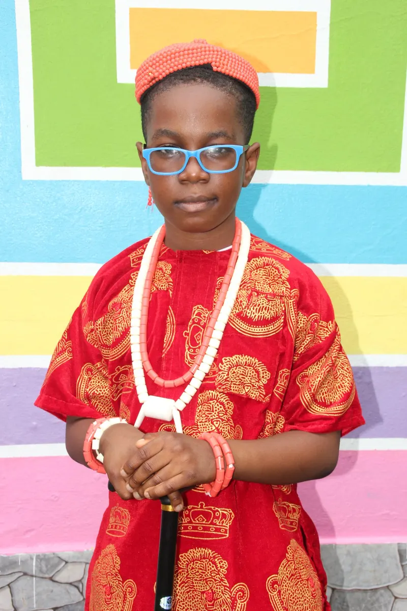 A pupil wearing traditional attire and coral beads for a cultural day celebration