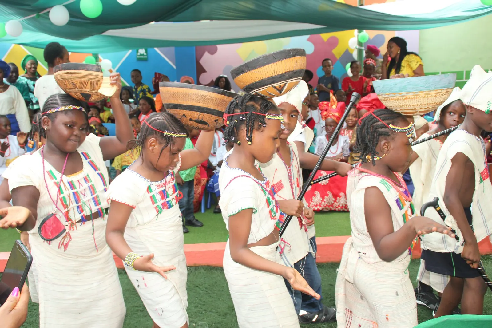 Pupils in traditional dress performing a dance during a cultural day celebration