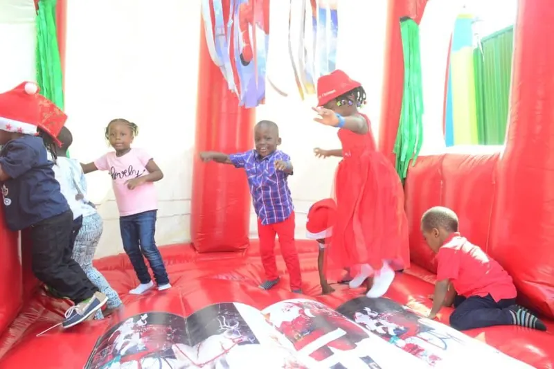 Children jumping on a bouncy castle at a school party