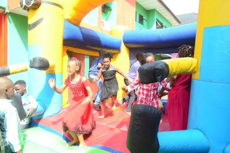 Children enjoying inflatable play equipment at a school party