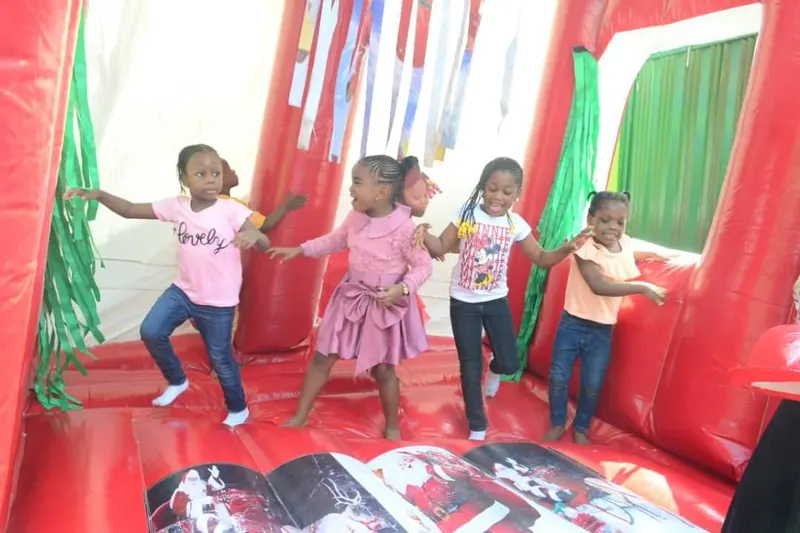 Children playing together on an inflatable at a school party