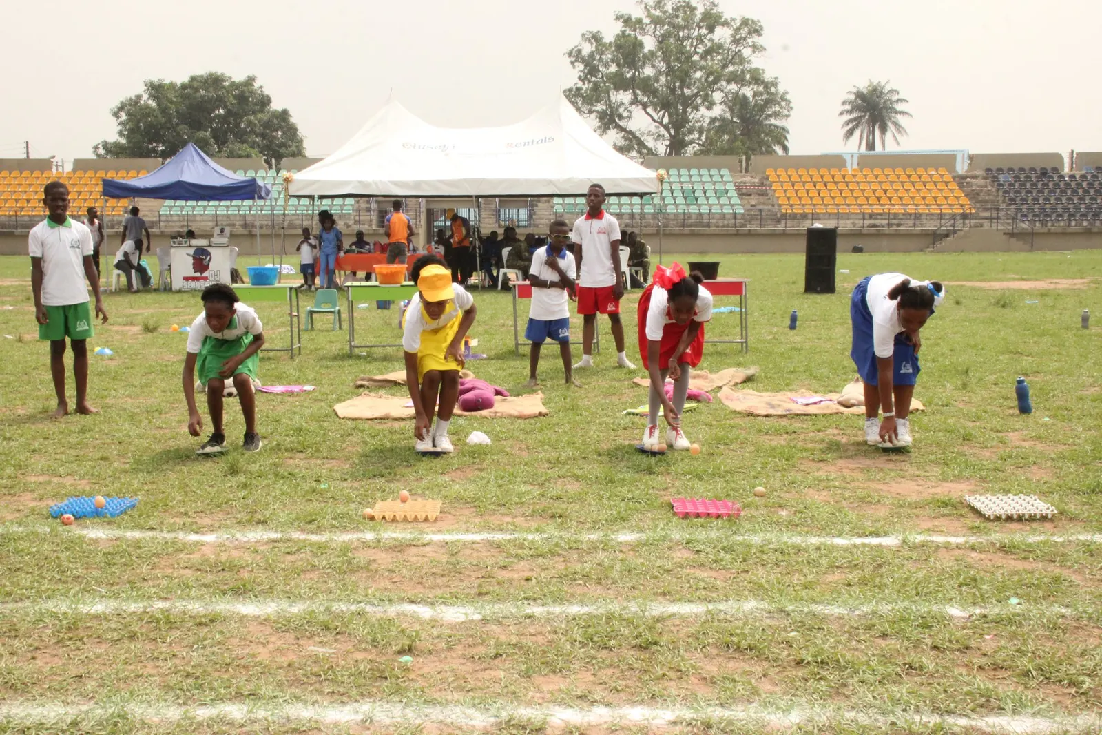 Children and teachers on the field during sports day activities