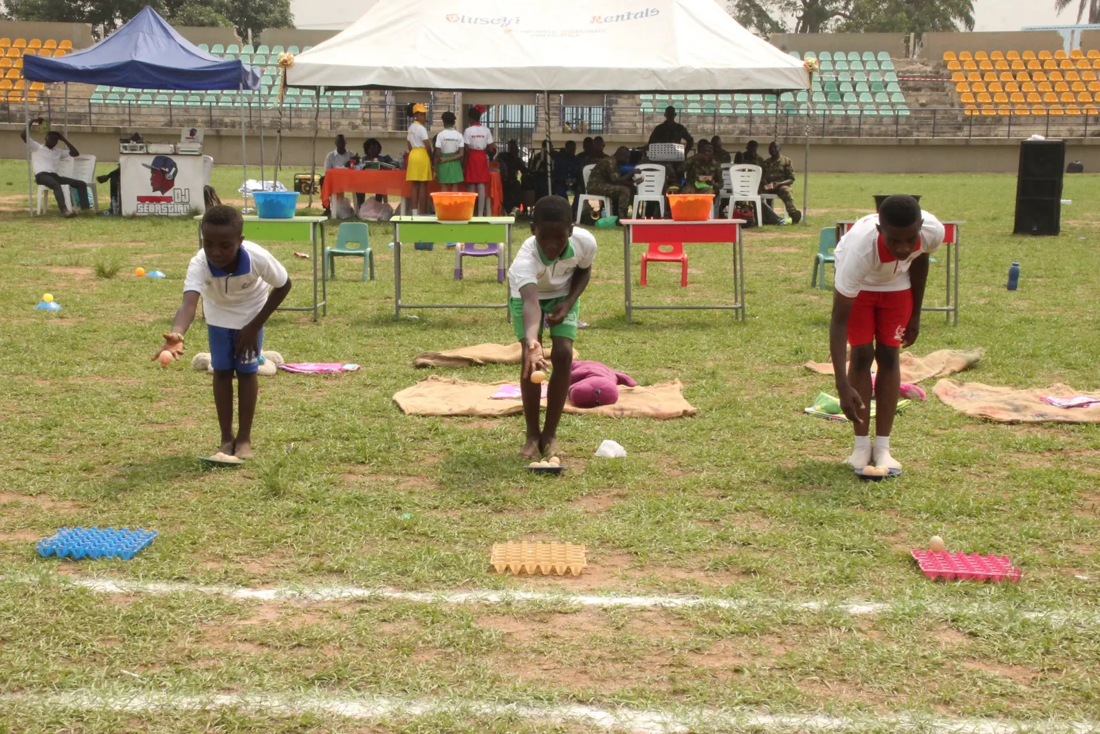 Pupils taking part in games on the field at a school sports day